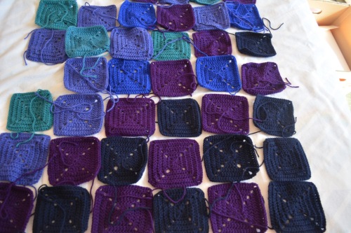 small crocheted squares in graded colours